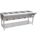 A stainless steel Advance Tabco hot food table with an undershelf holding food containers.