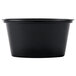 A black plastic Newspring Ellipso souffle cup with a lid.