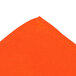 An orange cloth with a stitched edge.