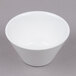 a white bowl on a gray surface