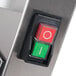 The green switch with a white line on a stainless steel Doyon DL18SP dough sheeter.