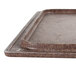 A close-up of a brown Vollrath Miramar granite resin template tray.