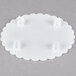 A white Wilton scalloped edge cake separator plate.