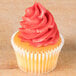 A cupcake with pink frosting piped on top using an Ateco closed star piping tip.