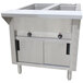An Advance Tabco stainless steel electric hot food table with sliding doors on a counter.