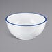 A white melamine bowl with a blue rim.