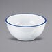 A white melamine bowl with a blue rim.
