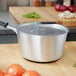 A Vollrath Wear-Ever aluminum pot cover on a pot.