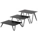 A black rectangular Cal-Mil metal riser set on a table.