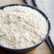 A bowl of white powder on a table.