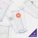 A group of empty clear plastic pint glasses.