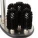 A circular black brush with black bristles.