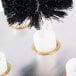 A close-up of a black and white Noble Products glass washer brush.