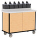 A Lakeside Hard Rock Maple condiment cart with black containers on top and wheels.
