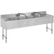 An Advance Tabco stainless steel four compartment bar sink with drainboards on a counter.