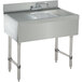 A stainless steel Advance Tabco bar sink with two drainboards and a faucet.