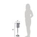 A woman standing next to a tall stainless steel wine stand with an insulated bucket on top.