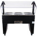 An Advance Tabco hot food table with an open base holding three trays.
