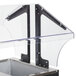 An Advance Tabco buffet table with a metal base and metal containers.