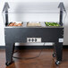 An Advance Tabco buffet table with food in open wells.
