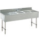 An Advance Tabco stainless steel underbar sink with three compartments and two drainboards.