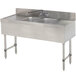 An Advance Tabco stainless steel underbar sink with two bowls, two drainboards, and a faucet.