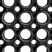 A black rubber mat with white circles on it.