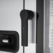 A silver door handle with a black grip on a Convotherm combi oven.
