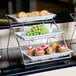 An American Metalcraft chrome three-tier display stand holding cupcakes with red and white frosting.