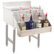 Advance Tabco stainless steel hang-on heavy-duty speed rail on a silver bar with bottles of alcohol.