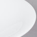 A close up of a white bowl on a white surface.