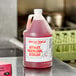 A jug of Advantage Chemicals concentrated liquid dish washing machine detergent on a counter with a label.