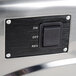 A close-up of a stainless steel Galaxy meat grinder switch.