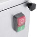 A close-up of a red switch with a white circle on a white surface.