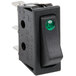 An Avantco lighted black rocker switch with a green light.