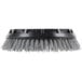 A black circular Oreck grit scrub brush with grey bristles.