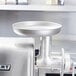 A stainless steel round feed pan for a Hobart meat grinder.