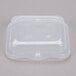 A clear plastic Vollrath steam table food pan lid on a clear plastic container.