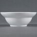 An American Metalcraft Prestige white stoneware bowl on a gray surface with a small rim.