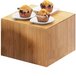 A group of muffins on a Cal-Mil bamboo square riser.