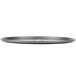 A close-up of a Chicago Metallic round black perforated pizza pan.