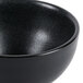A close up of a black Hall China chili bowl.