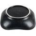 A black bowl with scalloped edges and a white rim.