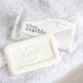 A white bar of Dial White Marble Basics soap on a white towel.