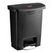 A black Rubbermaid Slim Jim step-on trash can with a lid.