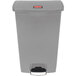 A grey Rubbermaid Slim Jim rectangular trash can with a red label.