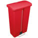 A red plastic Rubbermaid Slim Jim trash can with a lid.