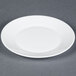 An Arcoroc white glass plate with a rim.