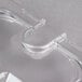 A Carlisle clear plastic lid with a handle and spoon notch.