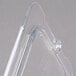 A close-up of a Carlisle clear plastic container with a universal handled lid and spoon notch.